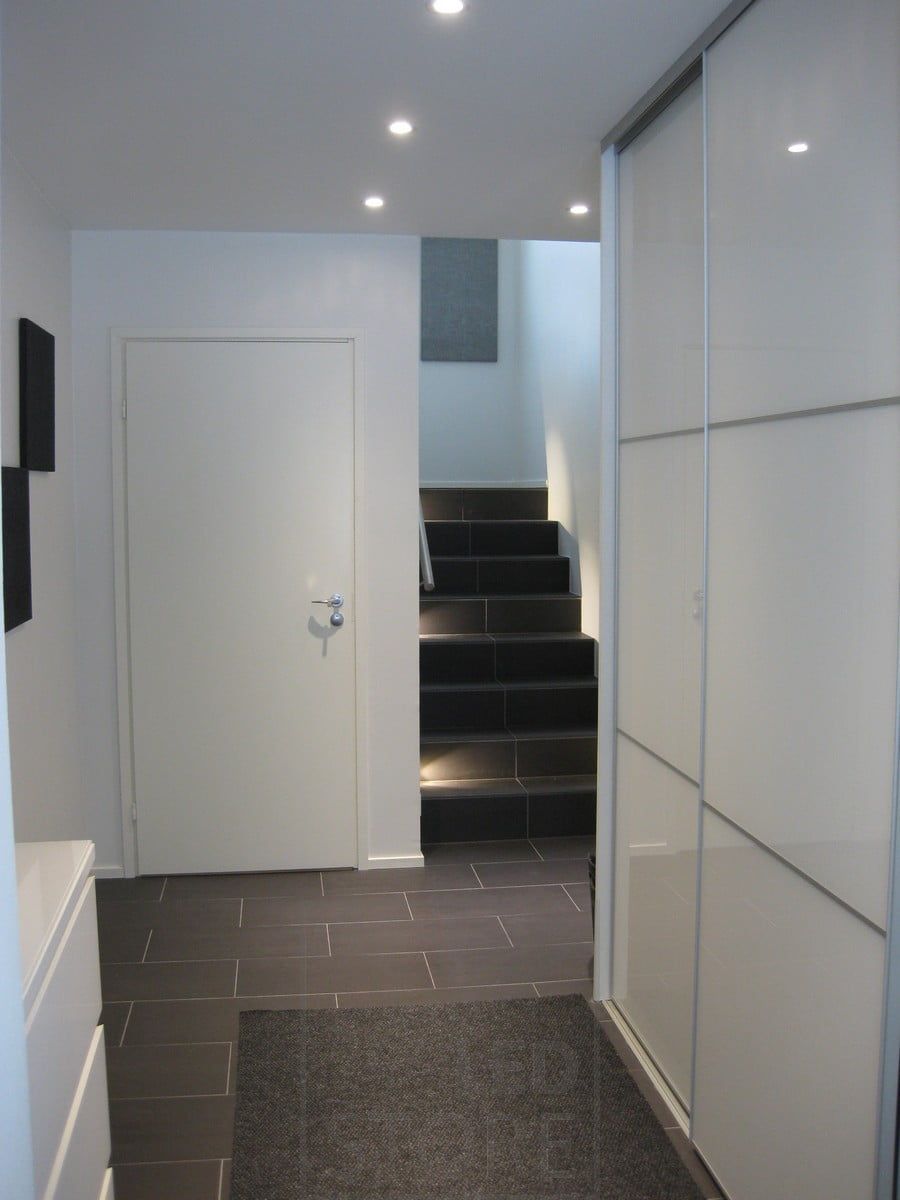 Staircase with step lighting, spotlights on the ceiling.
